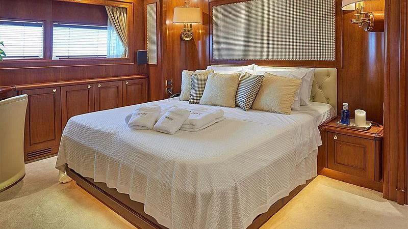 a bed with pillows on it aboard IMAGINE Yacht for Charter