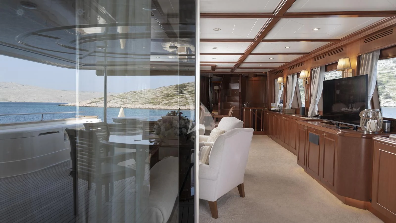 a room with a large window and a view of the ocean aboard IMAGINE Yacht for Charter