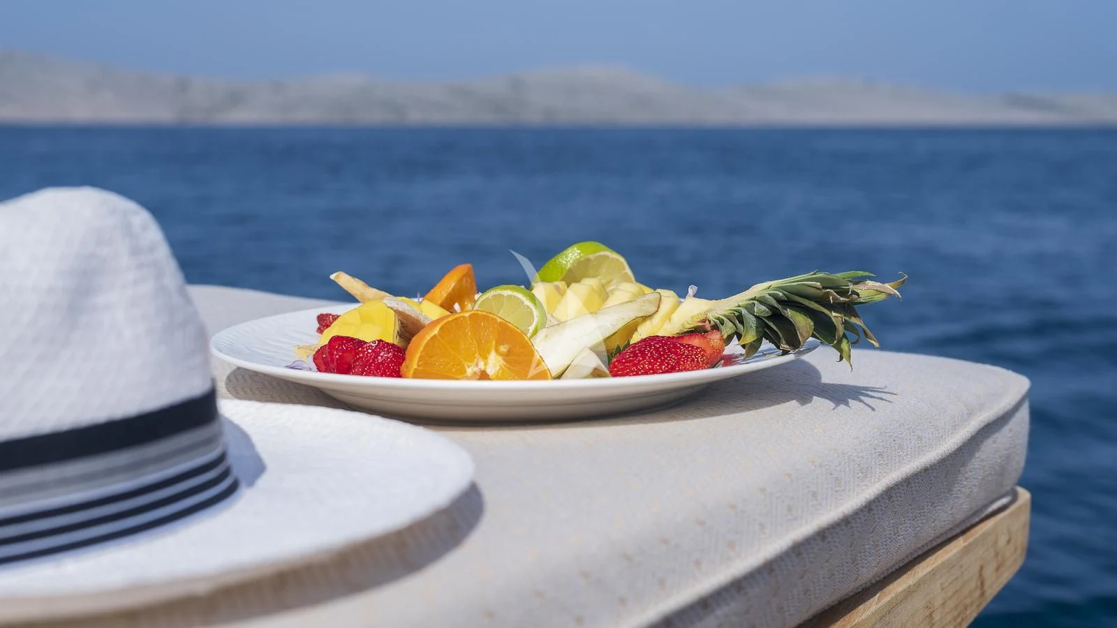 a plate of fruit on a boat aboard IMAGINE Yacht for Charter