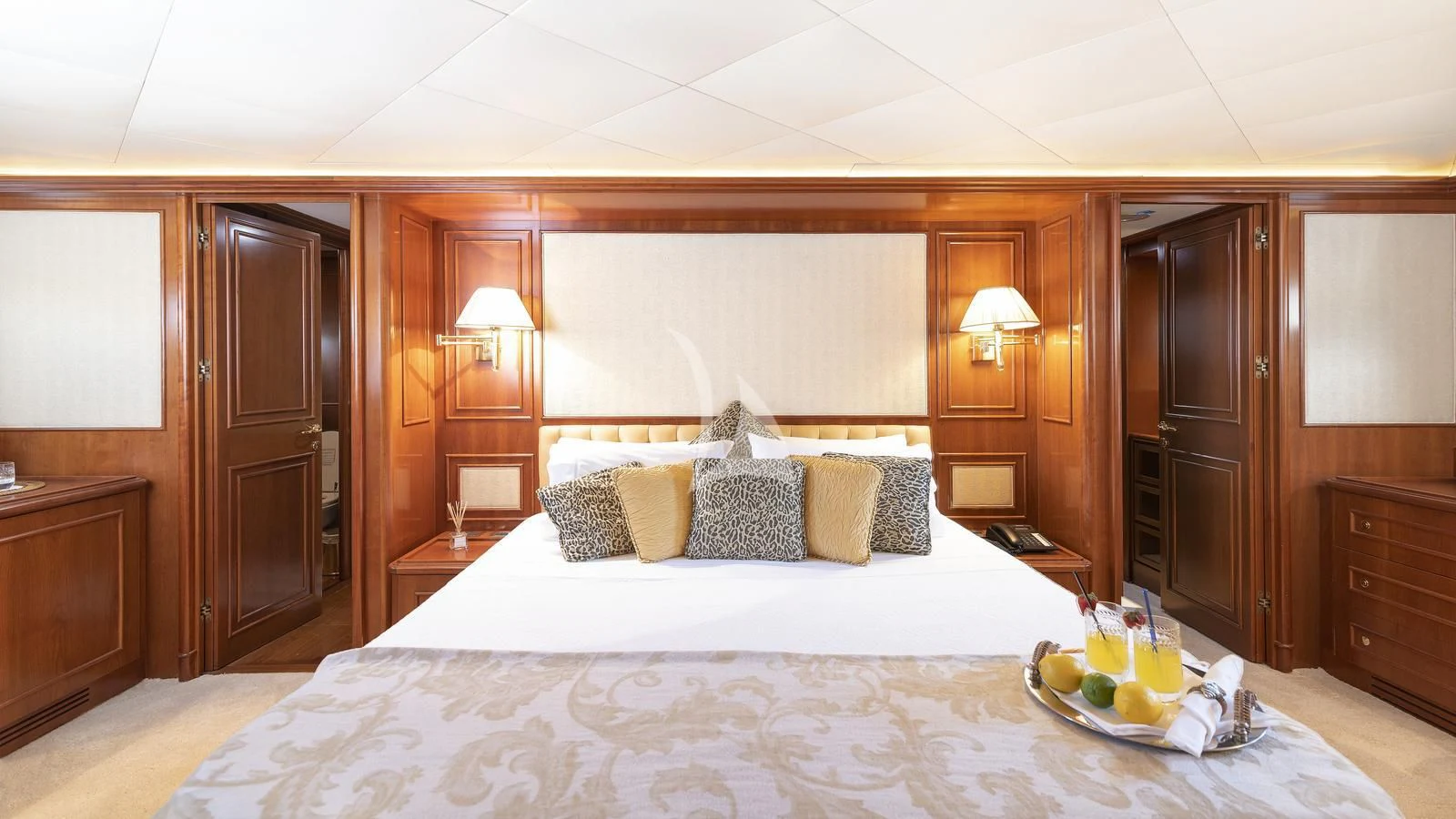 a bed with a tray of fruit aboard IMAGINE Yacht for Charter