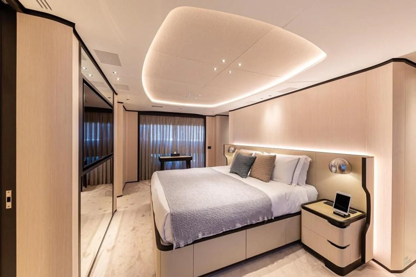 a bedroom with a bed and a desk aboard UNDICI Yacht for Sale