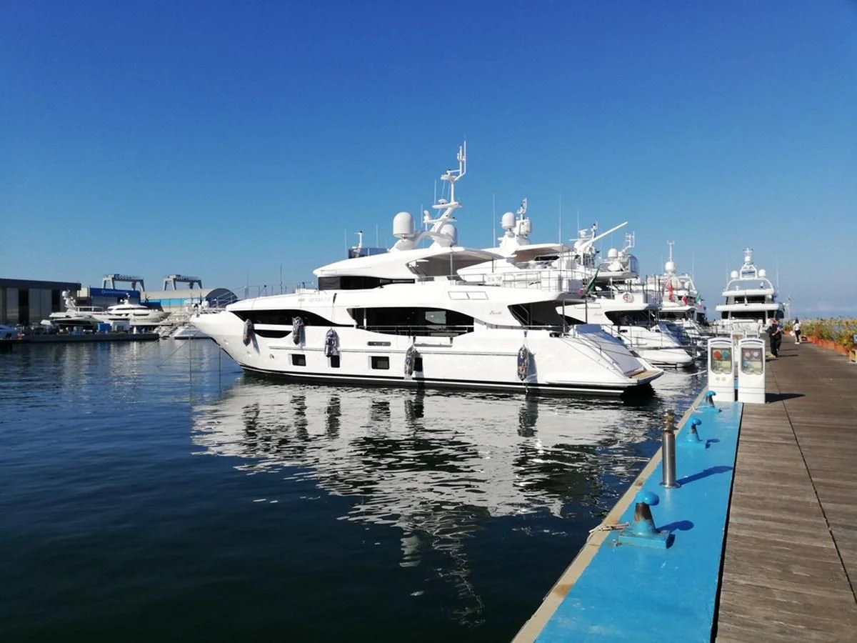 a boat docked at a pier aboard UNDICI Yacht for Sale
