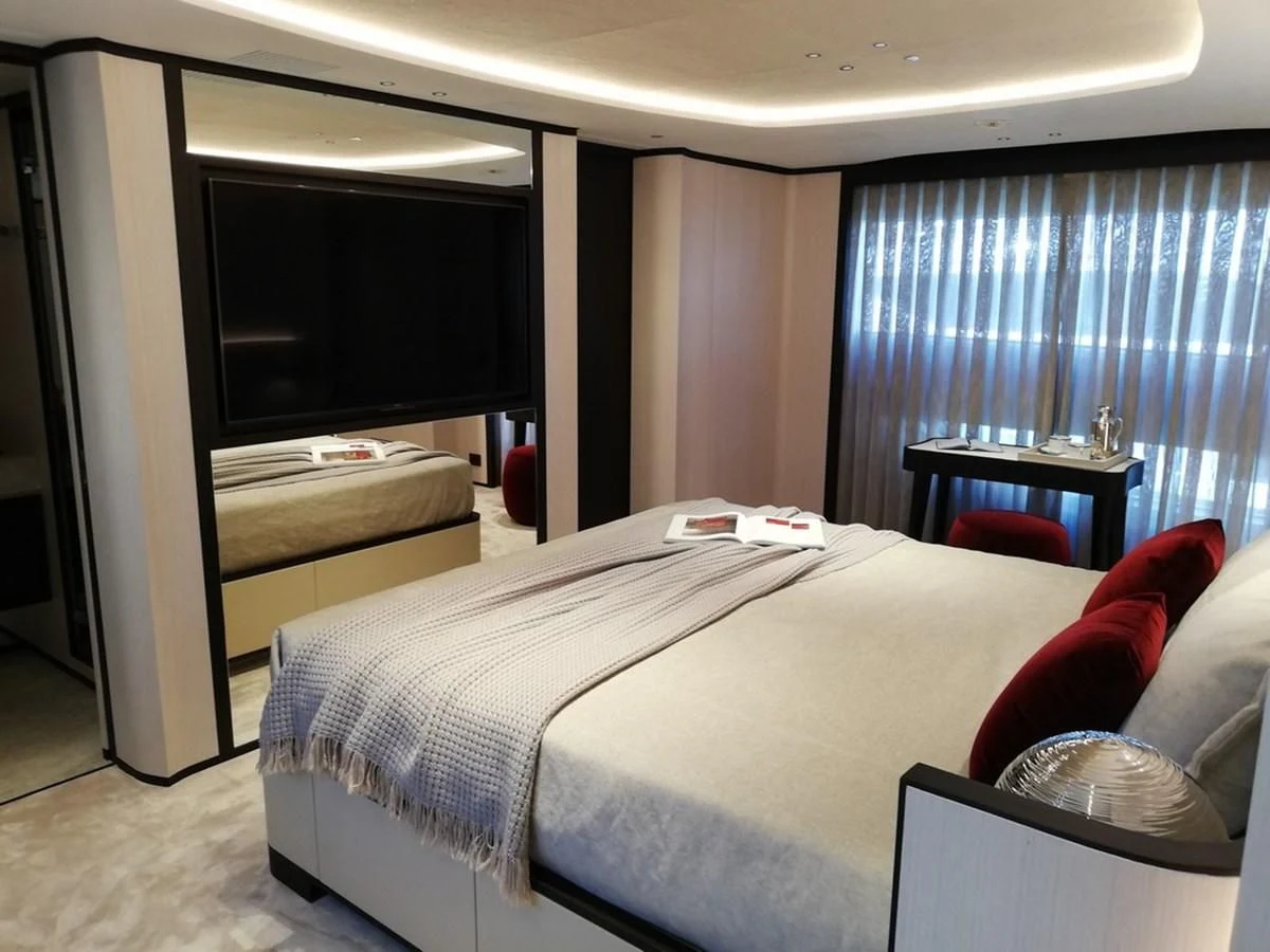 a hotel room with a bed and tv aboard UNDICI Yacht for Sale