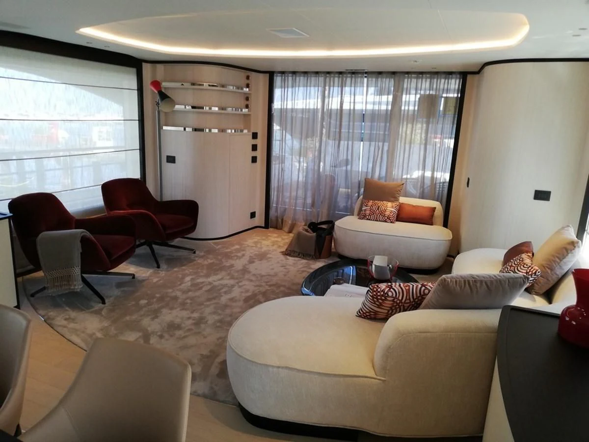 a living room with a large window aboard UNDICI Yacht for Sale