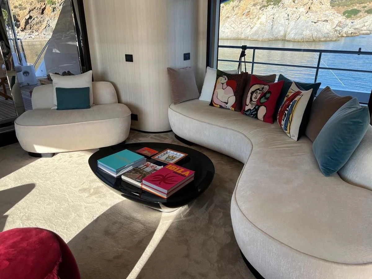 a living room with a couch and a coffee table aboard UNDICI Yacht for Sale