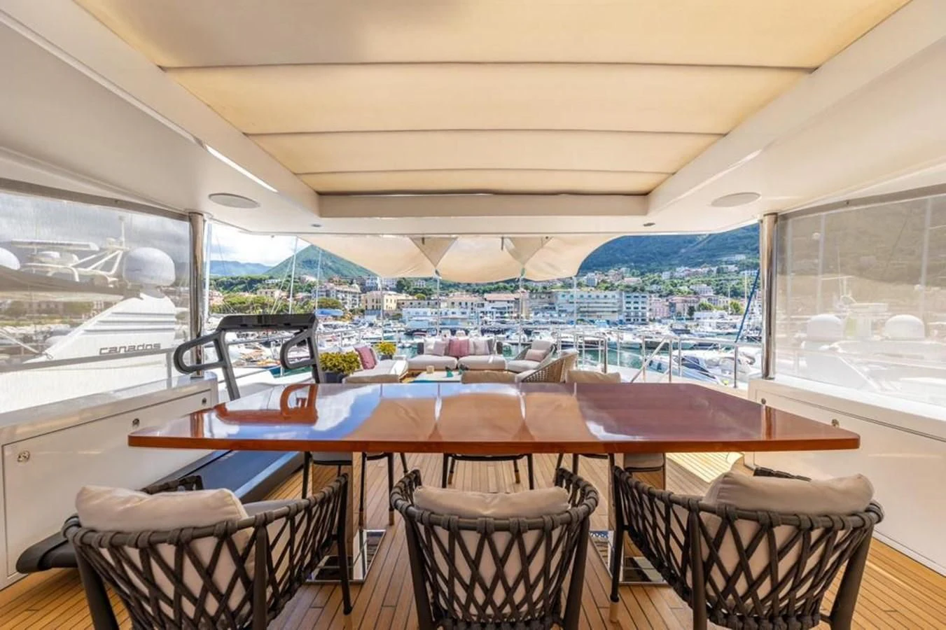 a room with a table and chairs aboard UNDICI Yacht for Sale