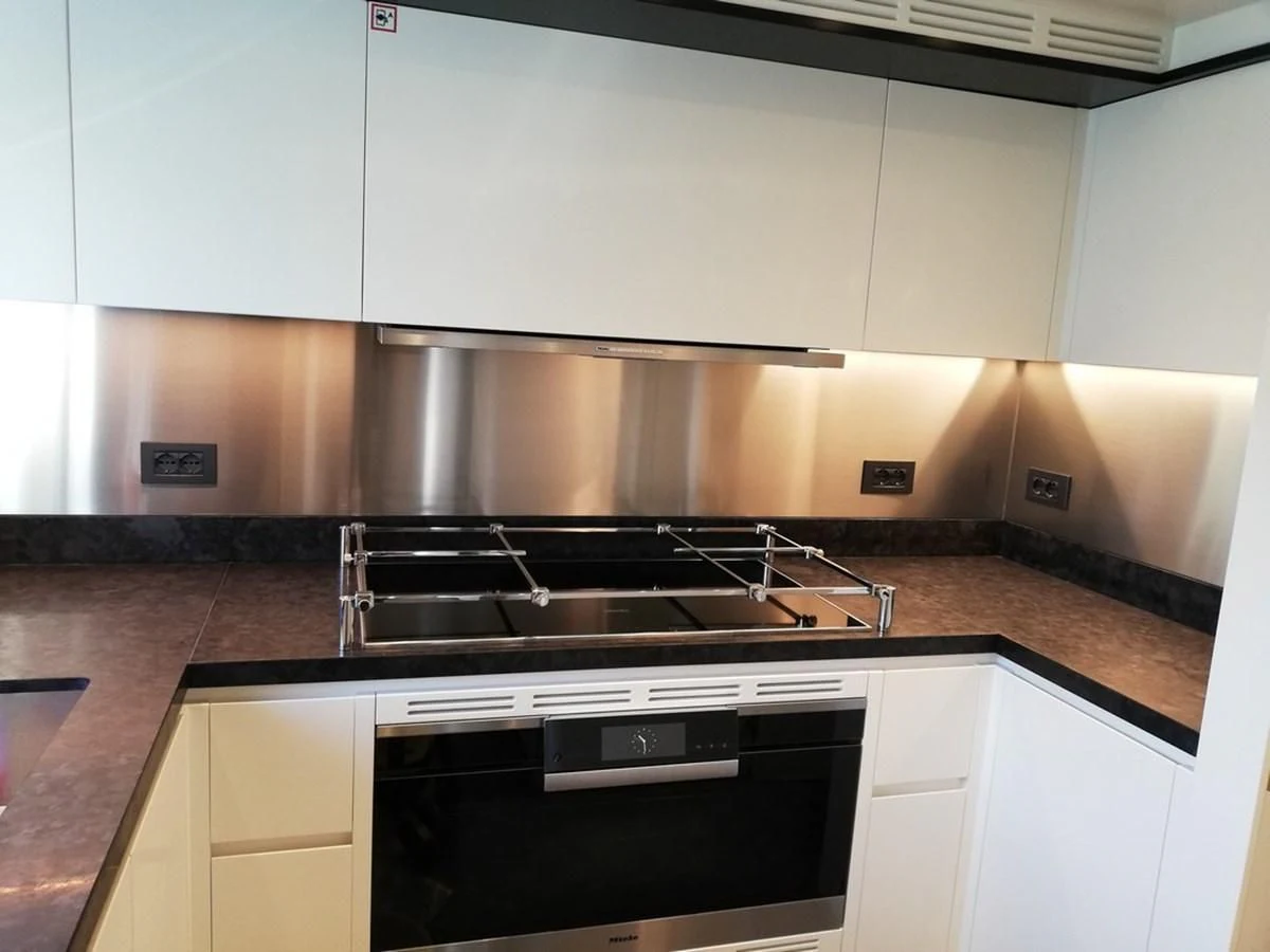 a kitchen with a stainless steel sink aboard UNDICI Yacht for Sale