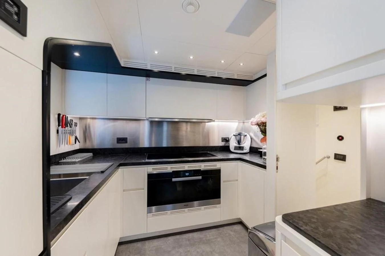 a kitchen with a stove and oven aboard UNDICI Yacht for Sale