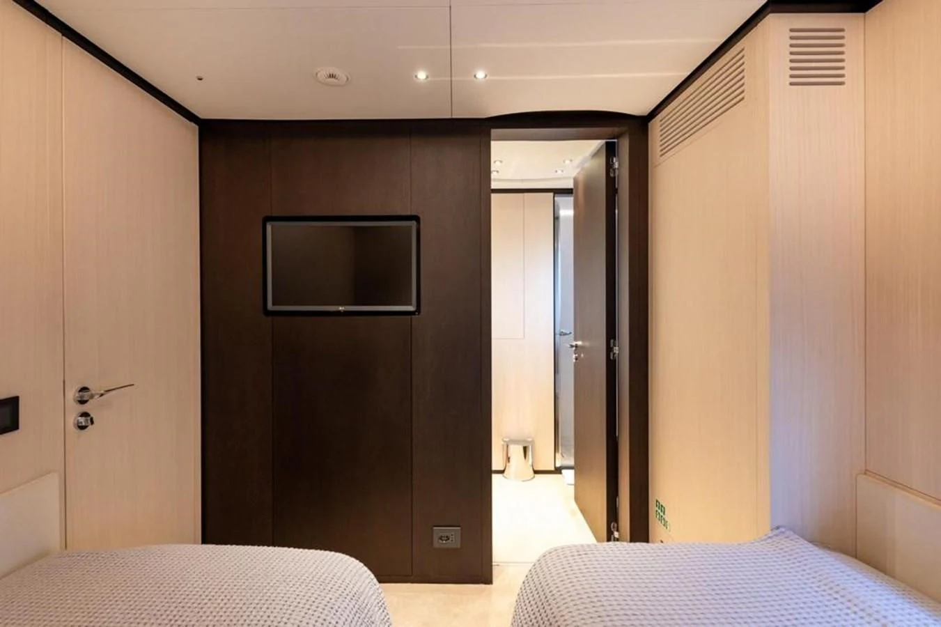 a room with a bed and a television aboard UNDICI Yacht for Sale
