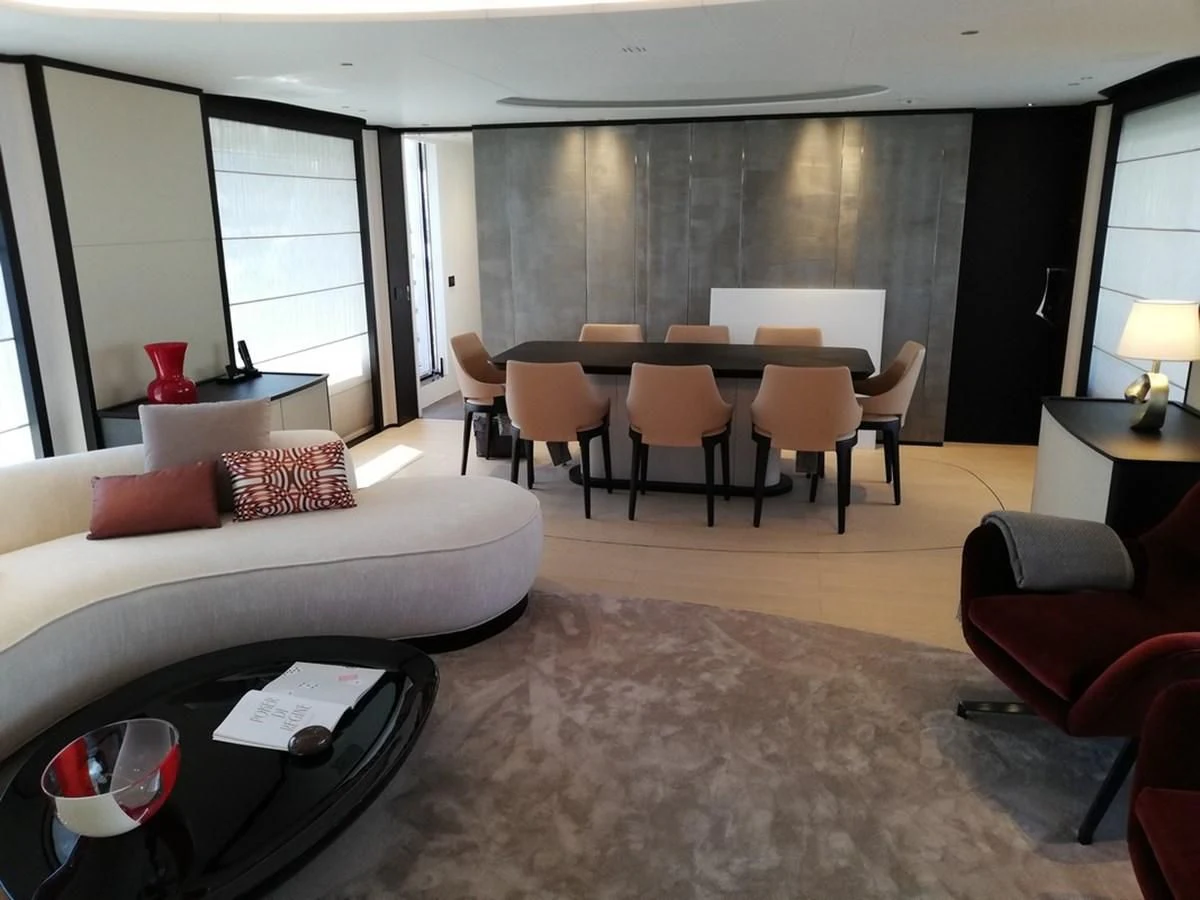 a living room with a couch and a table aboard UNDICI Yacht for Sale