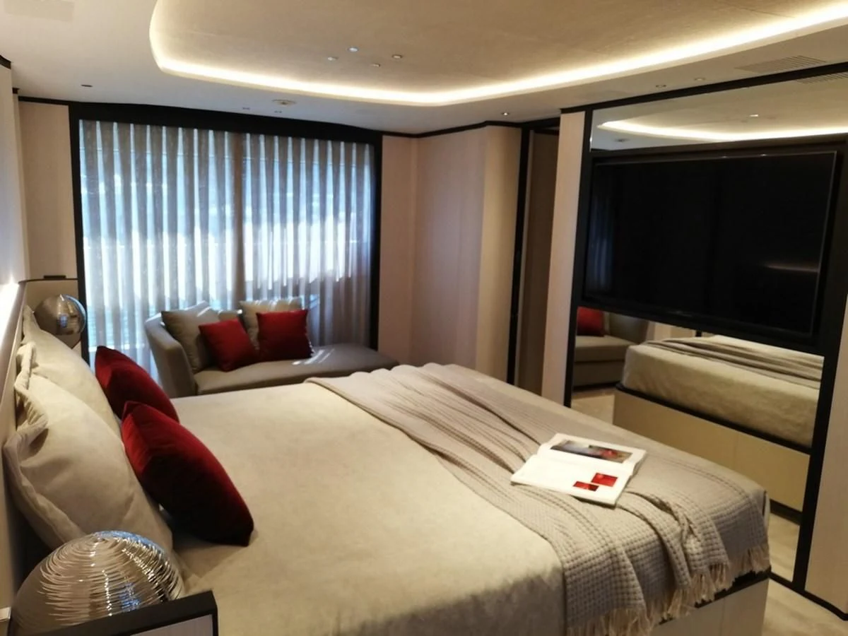 a hotel room with a bed and a window aboard UNDICI Yacht for Sale
