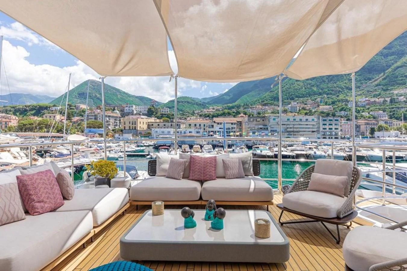 a patio with a table and chairs aboard UNDICI Yacht for Sale