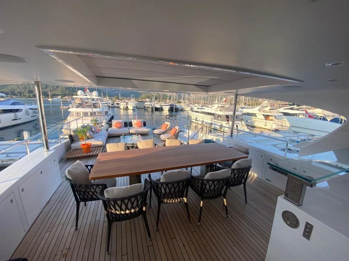 a deck with a view of the water and boats aboard UNDICI Yacht for Sale