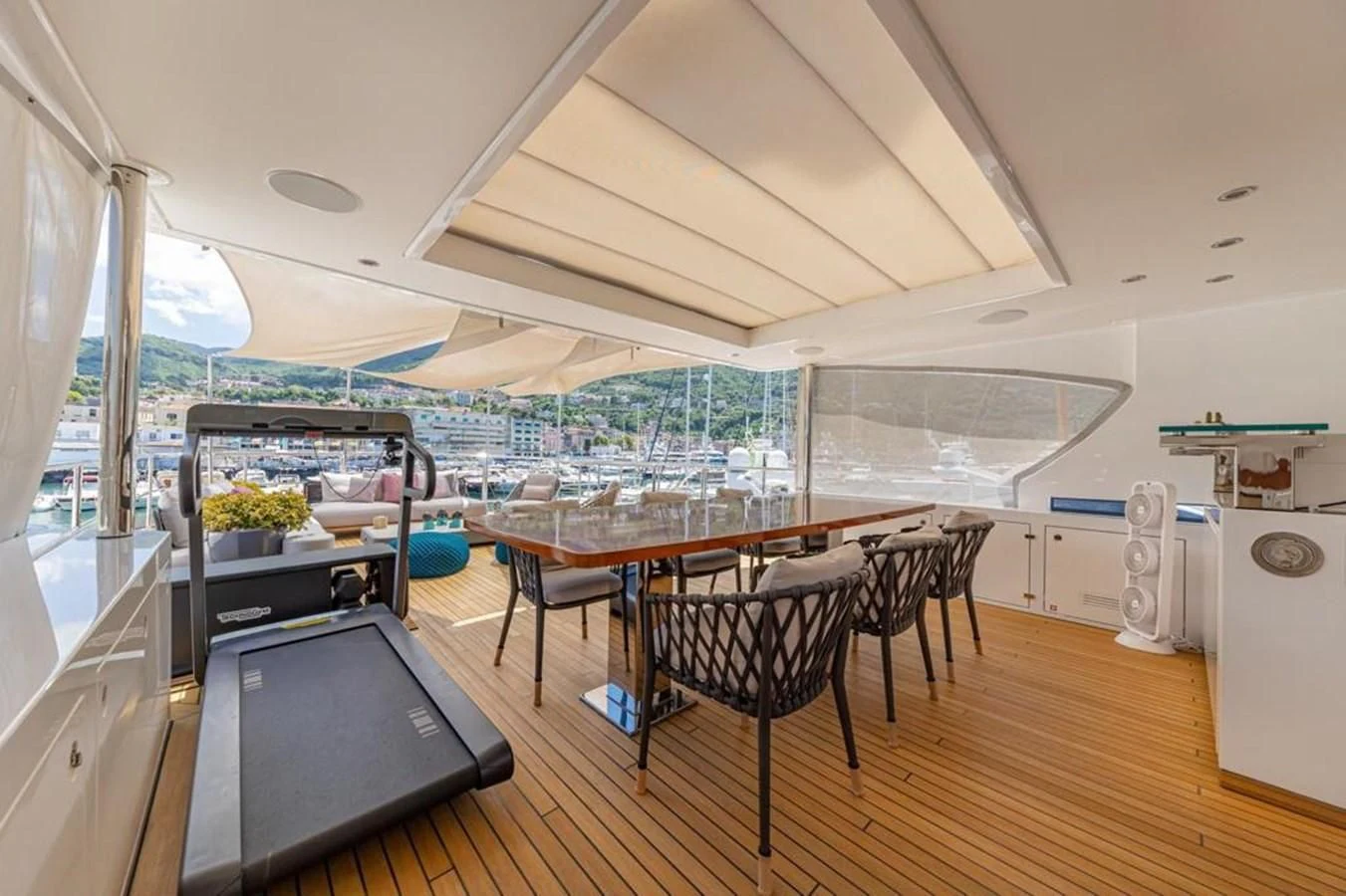 a room with a table and chairs aboard UNDICI Yacht for Sale