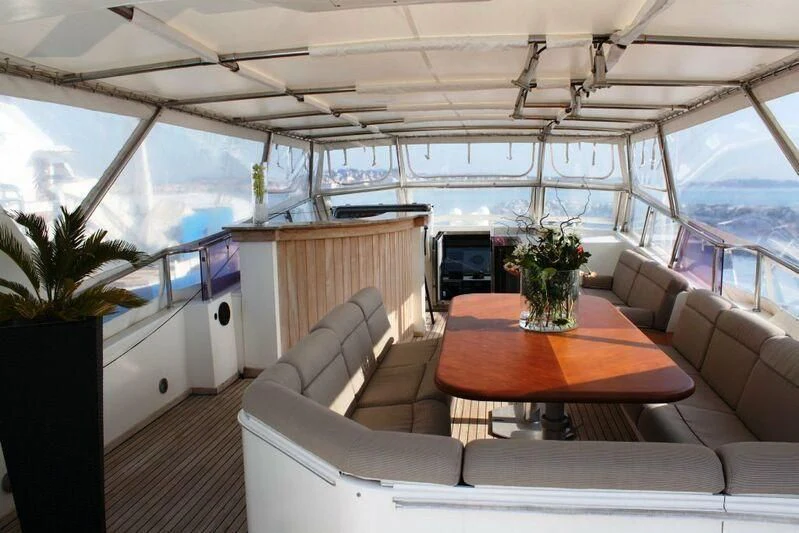 a room with a table and couches aboard AZURE RHAPSODY Yacht for Sale