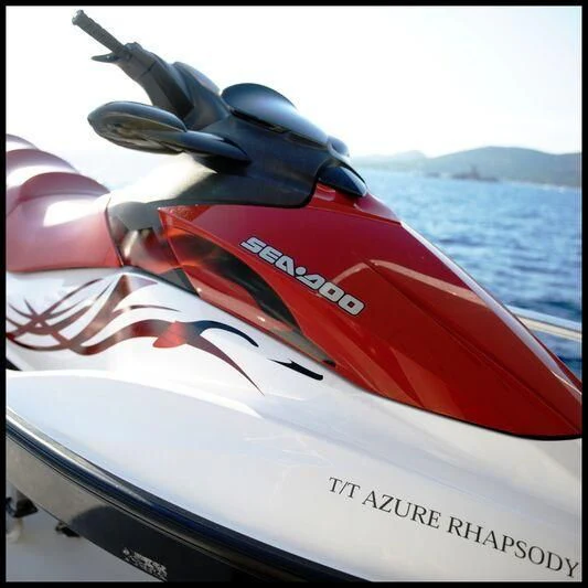 a hand holding a red and white kayak aboard AZURE RHAPSODY Yacht for Sale