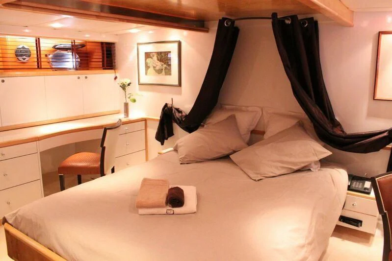 a bed with white sheets and pillows aboard AZURE RHAPSODY Yacht for Sale