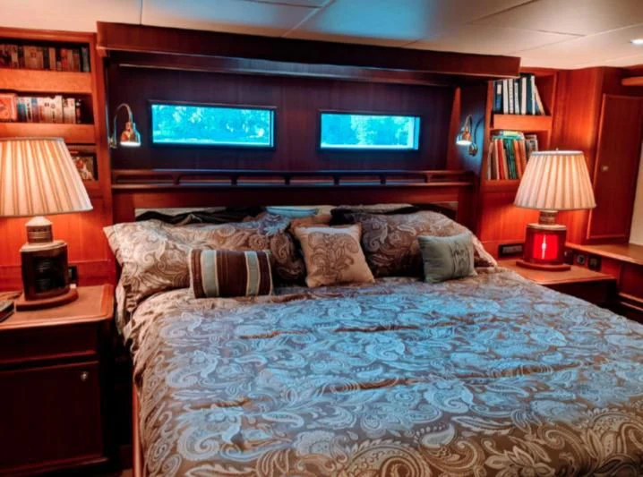 a bed with pillows and pillows aboard IIWII Yacht for Sale