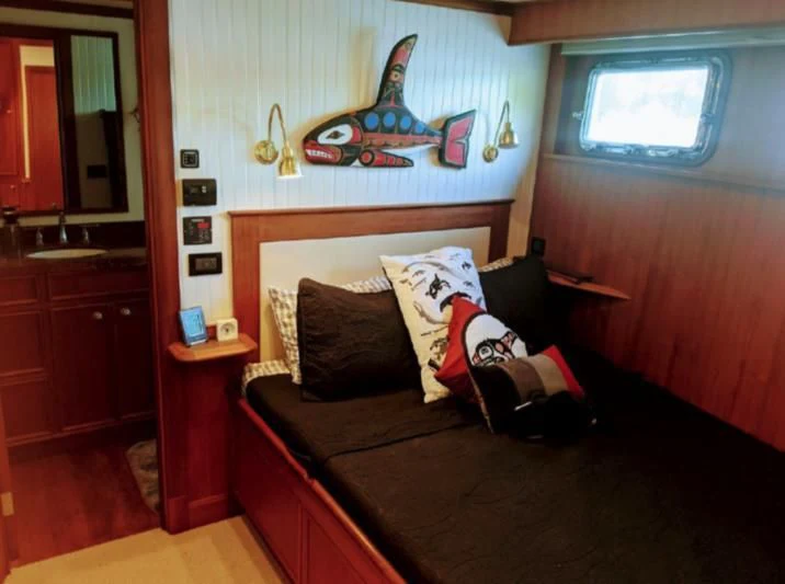 a couch in a room aboard IIWII Yacht for Sale