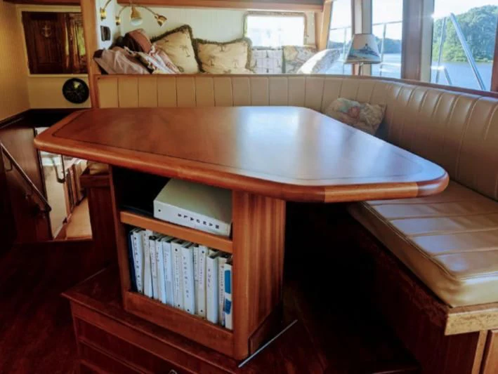 a table with books on it aboard IIWII Yacht for Sale