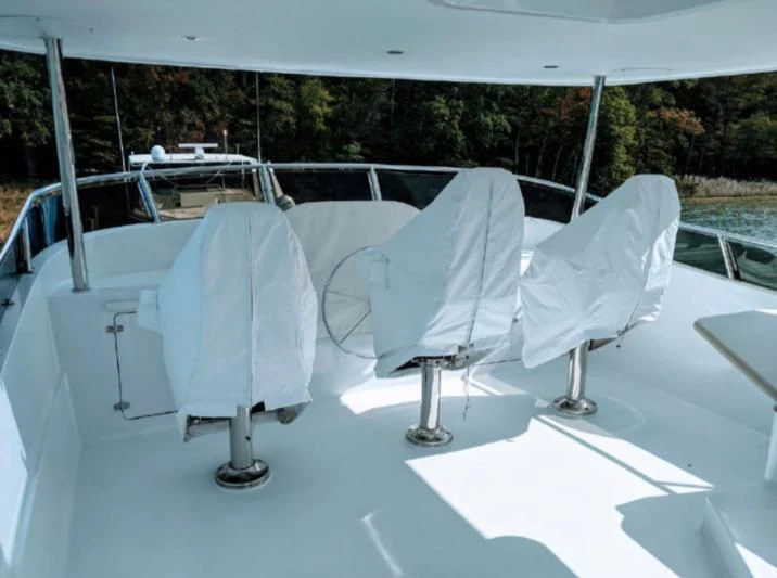a group of white chairs on a table outside aboard IIWII Yacht for Sale