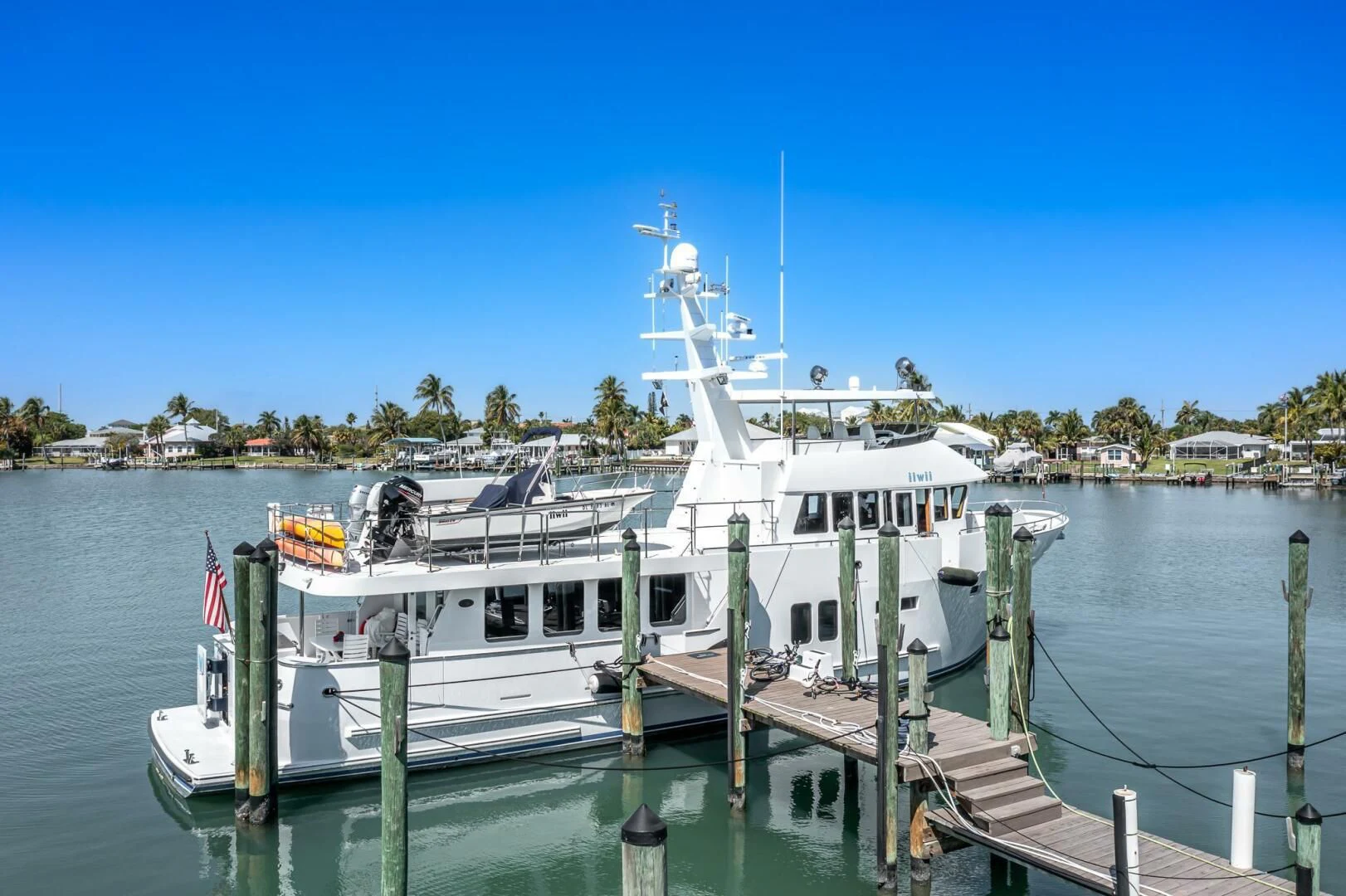 a boat docked at a pier aboard IIWII Yacht for Sale