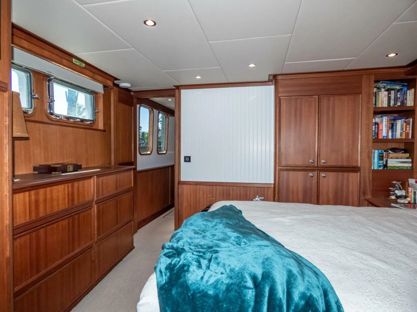 a bedroom with a bed and cabinets aboard IIWII Yacht for Sale