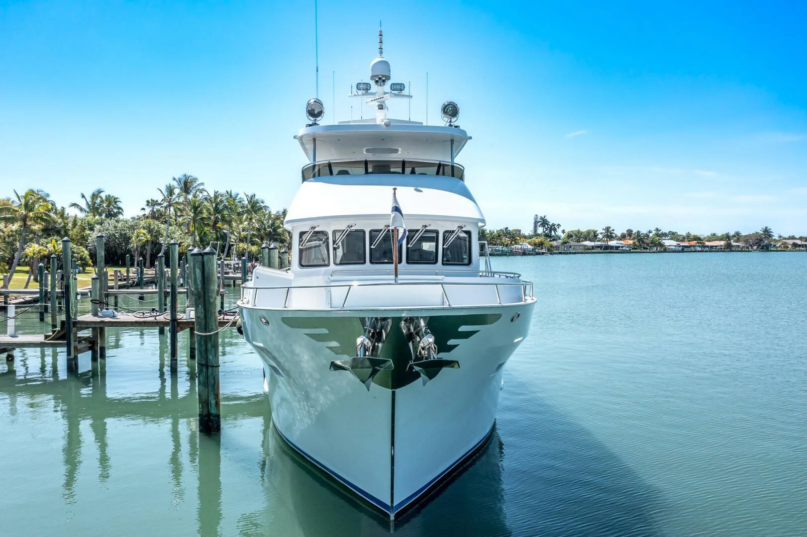 a white boat in a body of water aboard IIWII Yacht for Sale