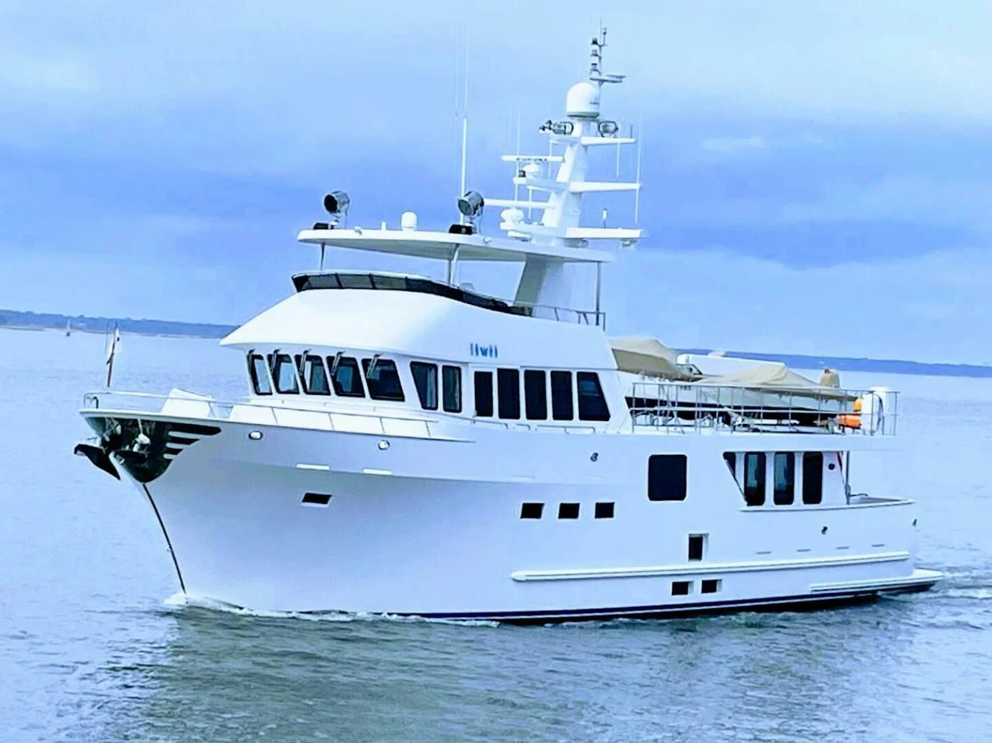a white boat in the water aboard IIWII Yacht for Sale