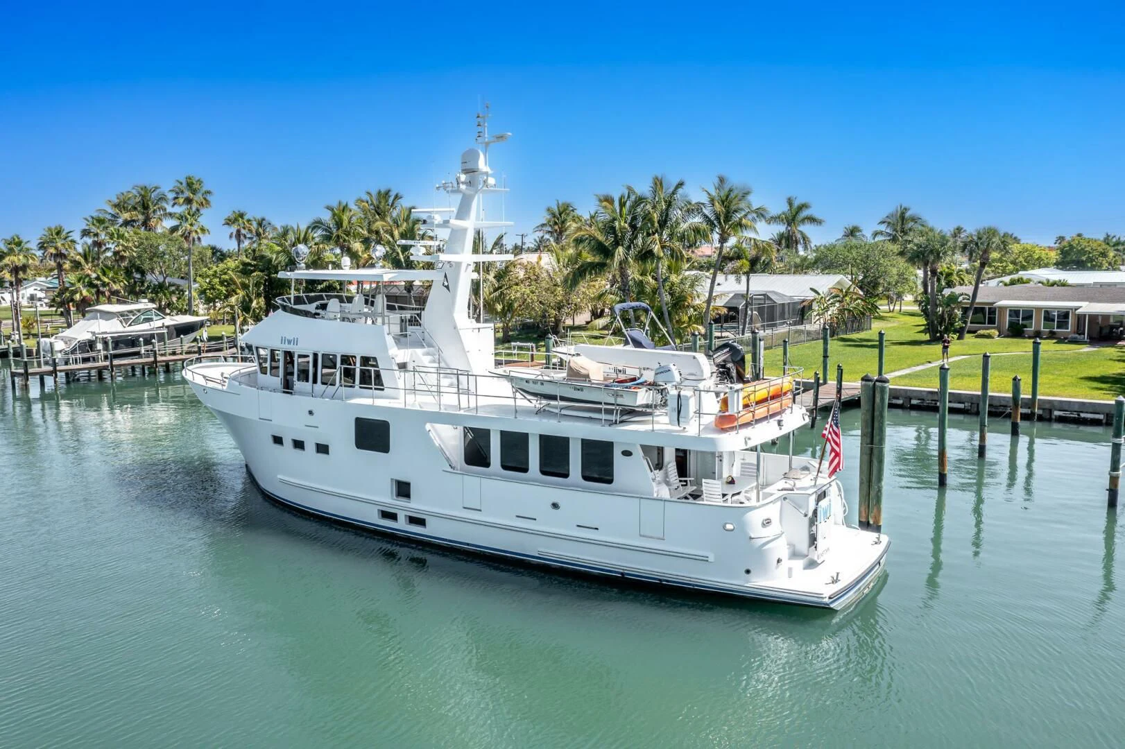 a white boat on a river aboard IIWII Yacht for Sale