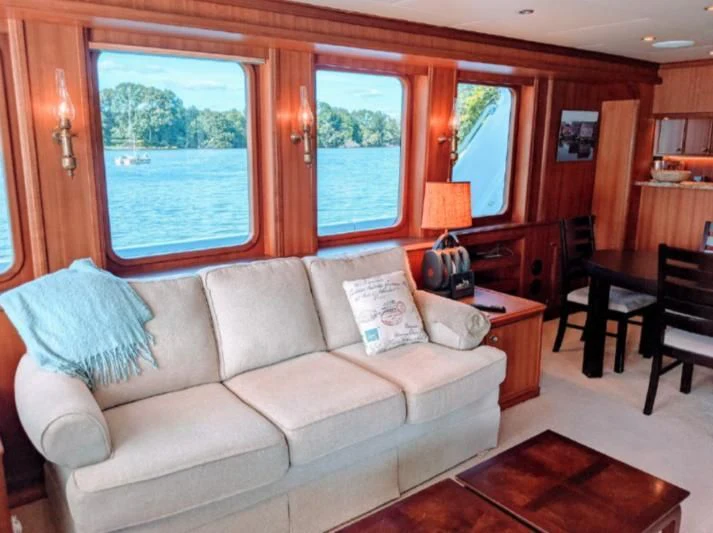 a living room with a couch and a window aboard IIWII Yacht for Sale