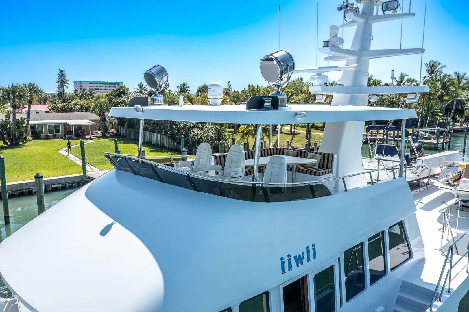 a large white boat with a satellite dish on top aboard IIWII Yacht for Sale