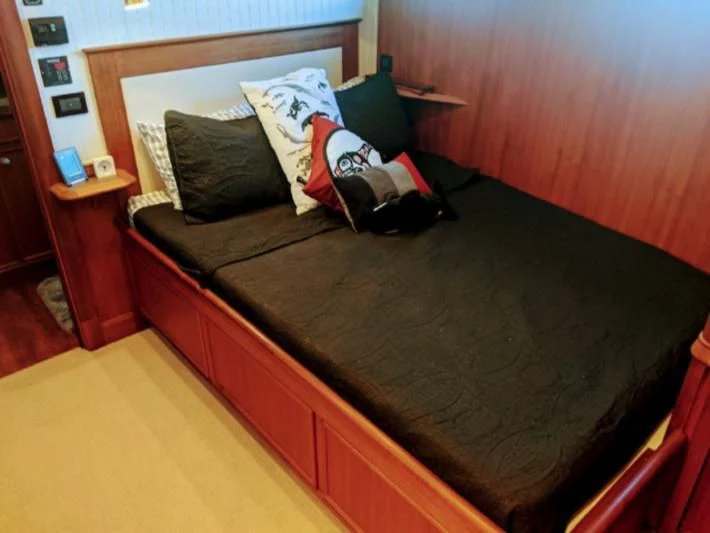 a bed with pillows aboard IIWII Yacht for Sale