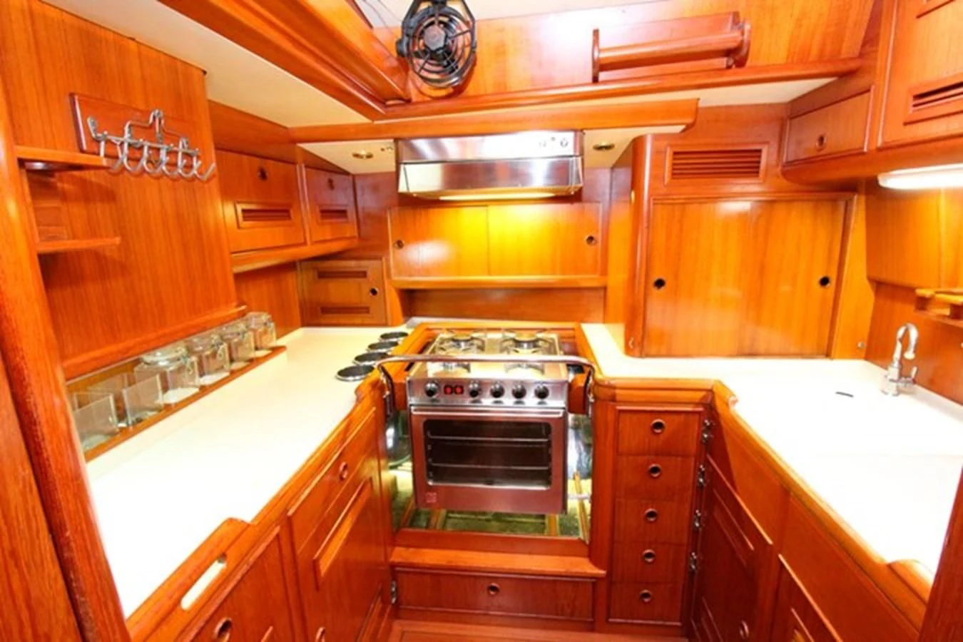 a kitchen with wooden cabinets aboard PLUM Yacht for Sale