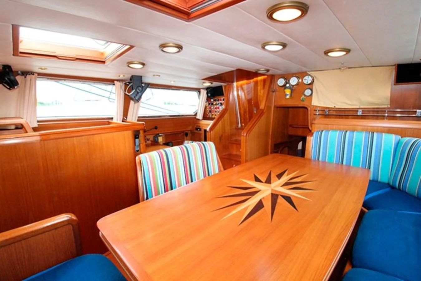 a room with a table and chairs aboard PLUM Yacht for Sale