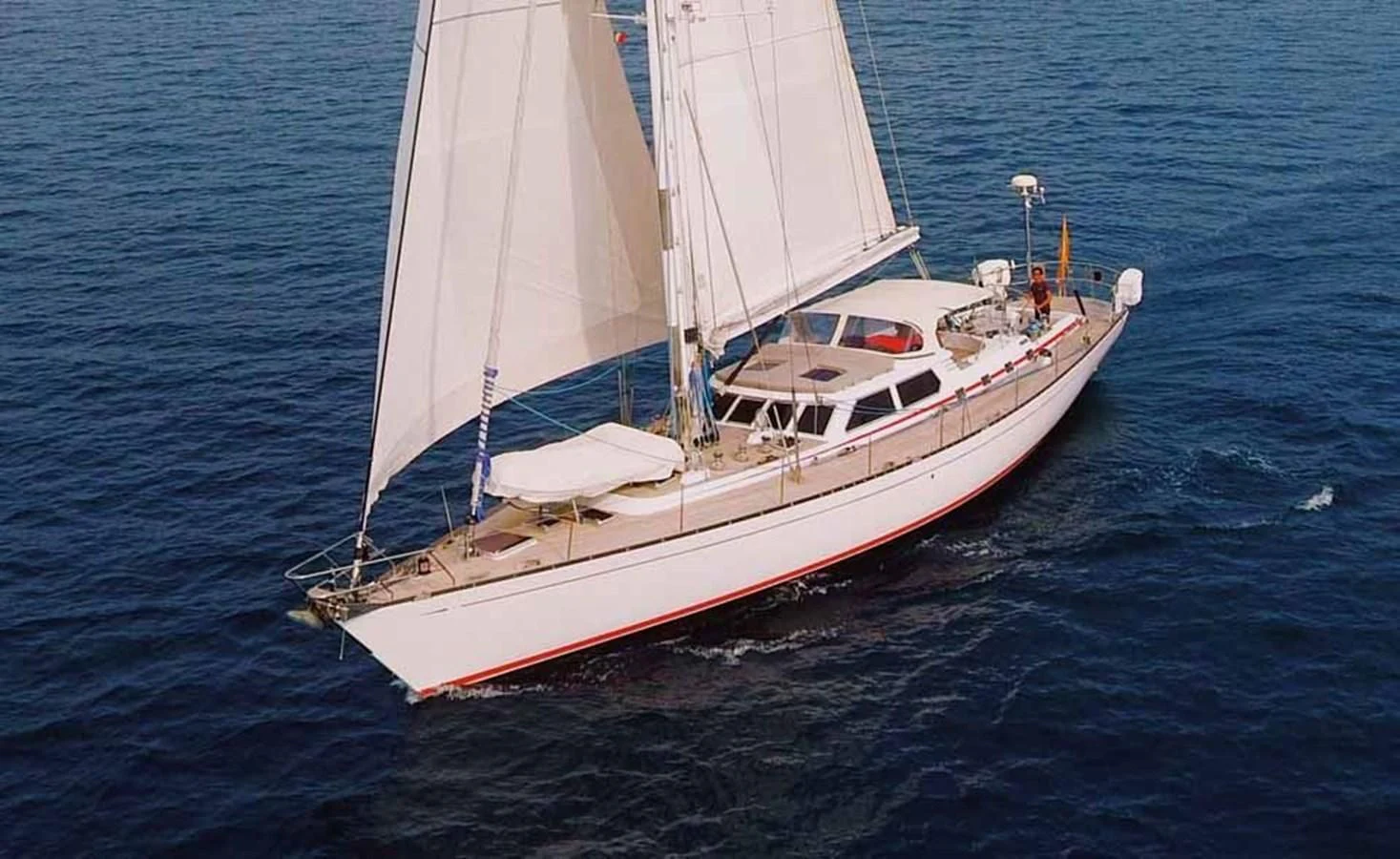 a white sailboat on the water aboard PLUM Yacht for Sale