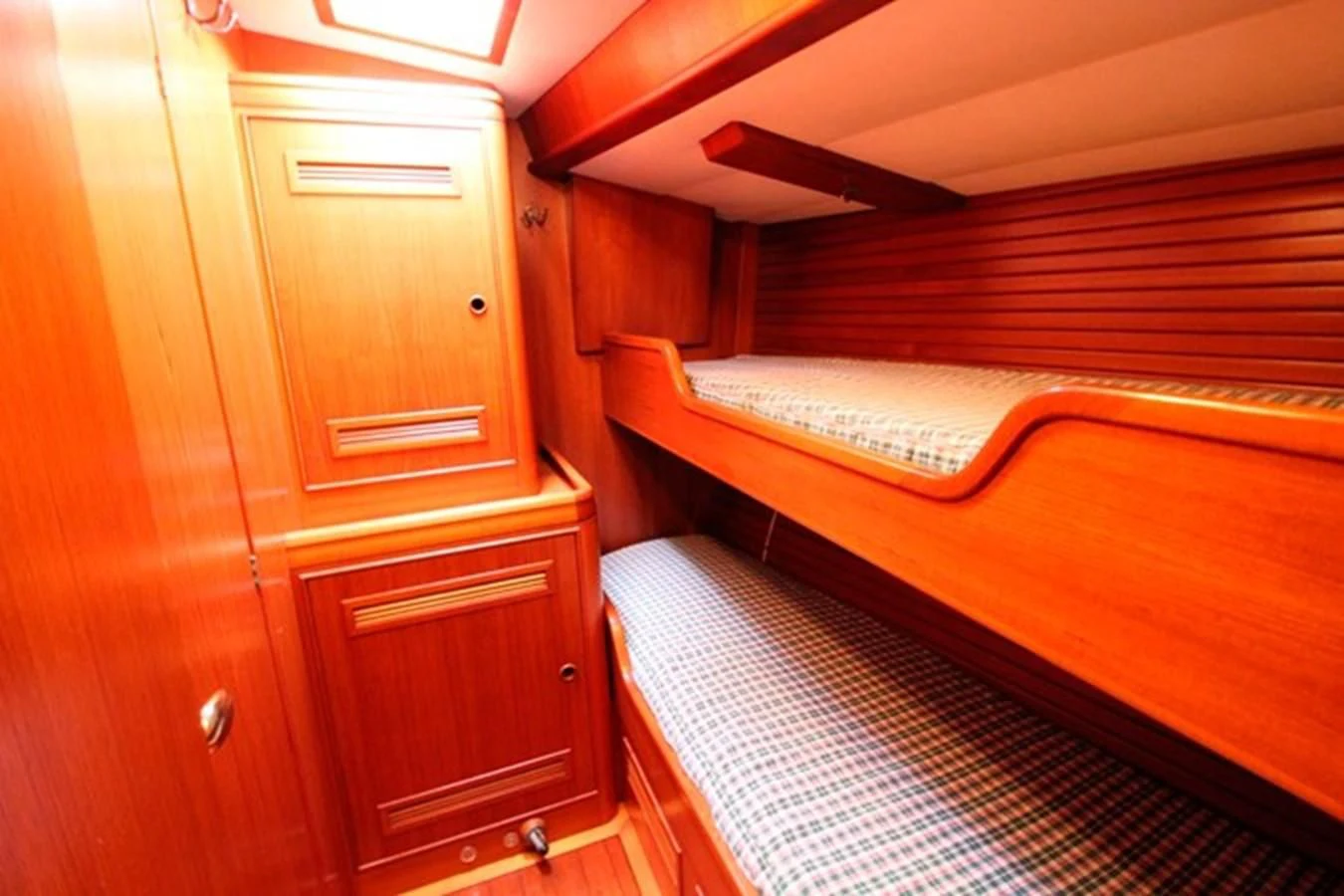 a room with wooden furniture aboard PLUM Yacht for Sale