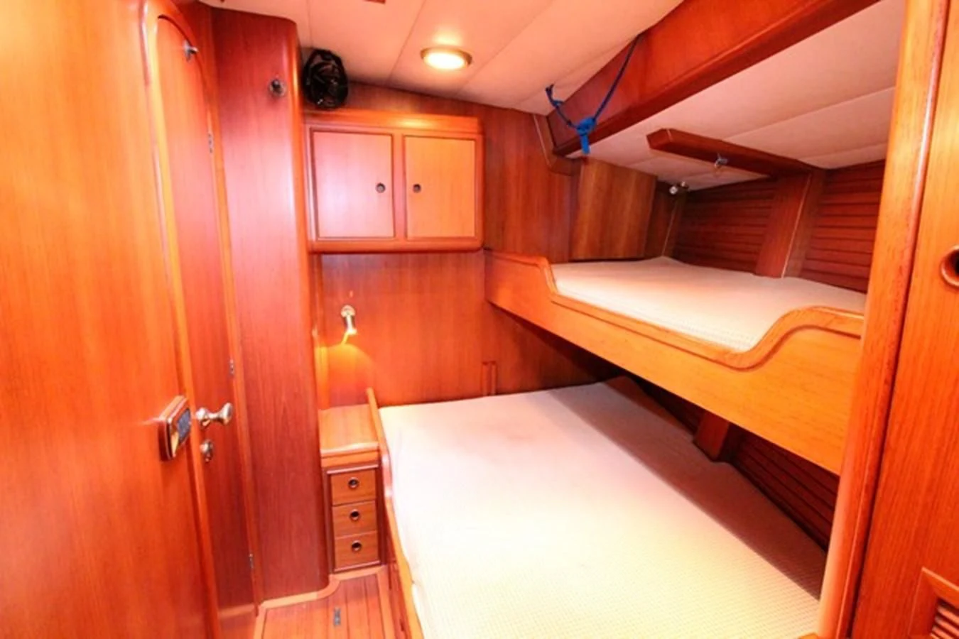 a bedroom with a bed and a closet aboard PLUM Yacht for Sale