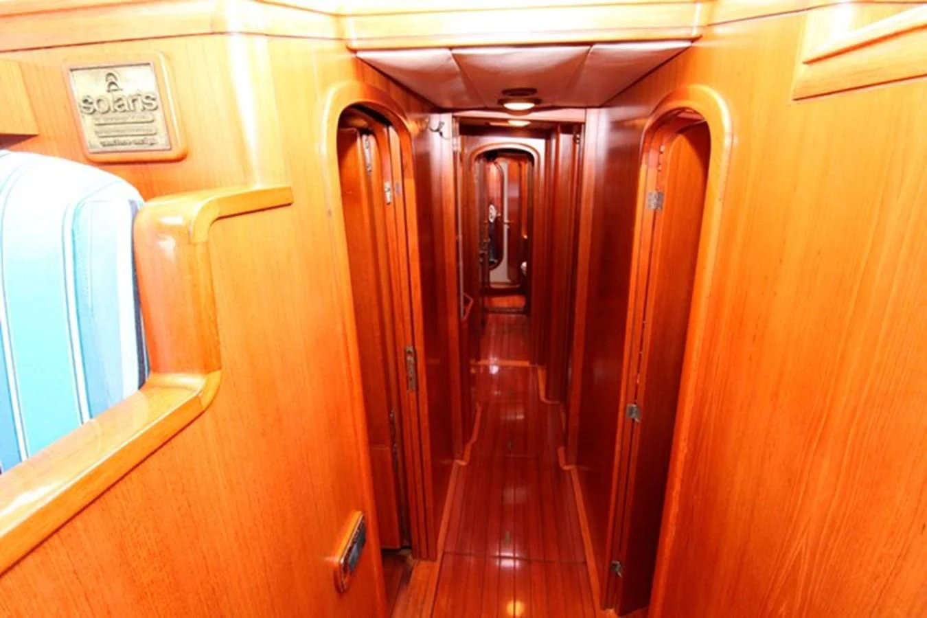a wood cabinet with doors aboard PLUM Yacht for Sale