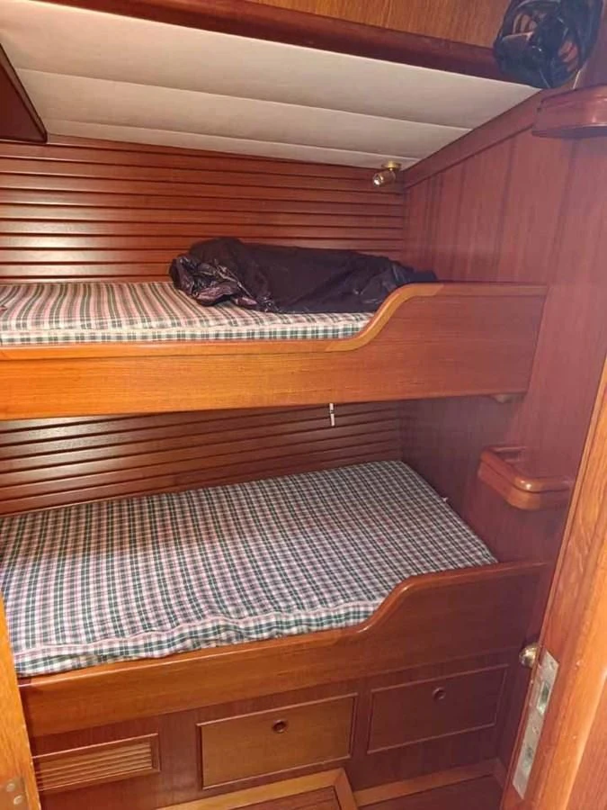 a couple of beds in a room aboard PLUM Yacht for Sale