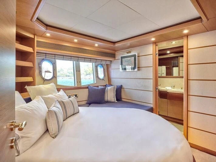 a room with a bed and a mirror aboard PAREAKKI Yacht for Sale
