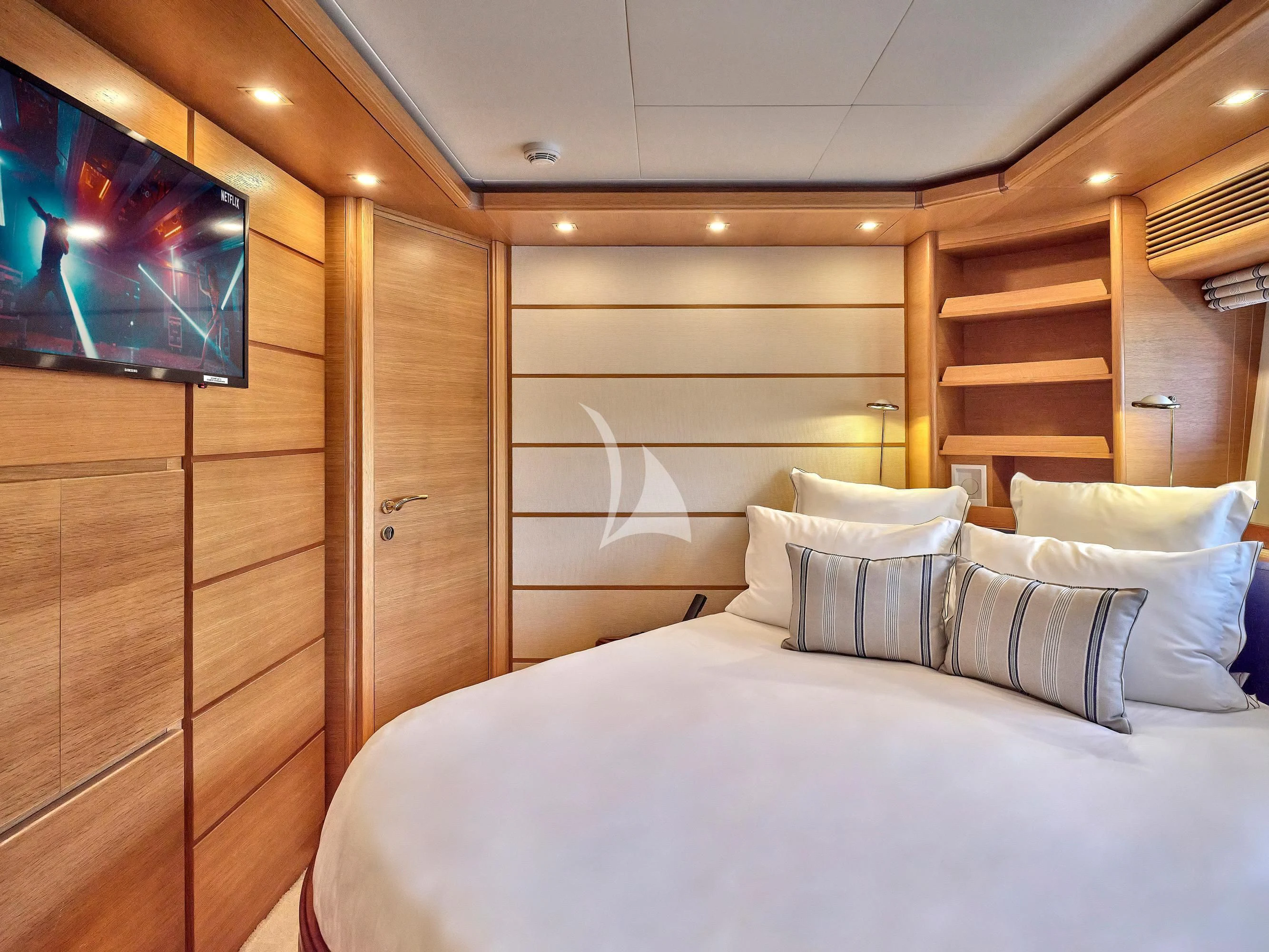 a bed with white sheets and pillows aboard PAREAKKI Yacht for Sale