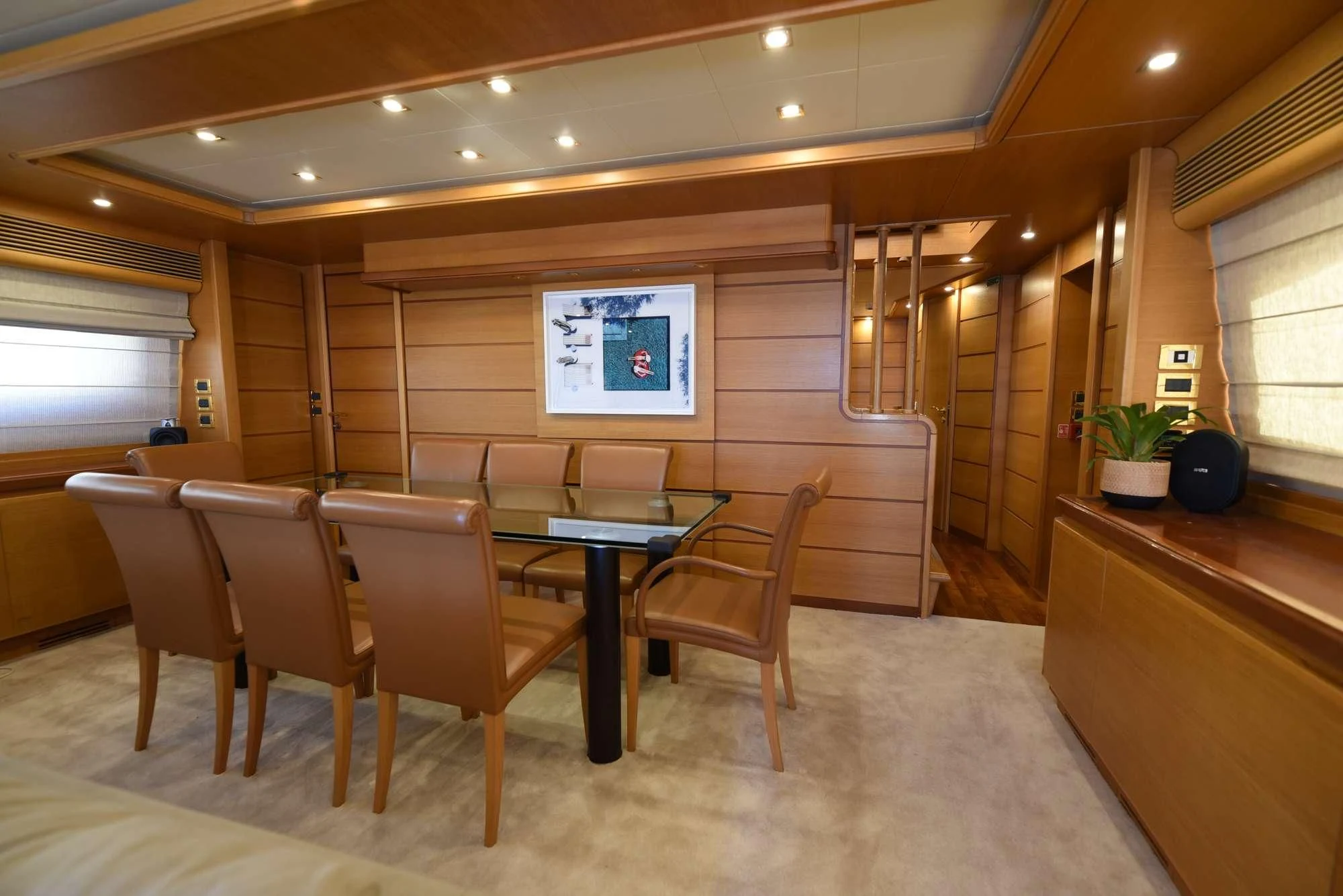 a room with tables and chairs aboard PAREAKKI Yacht for Sale