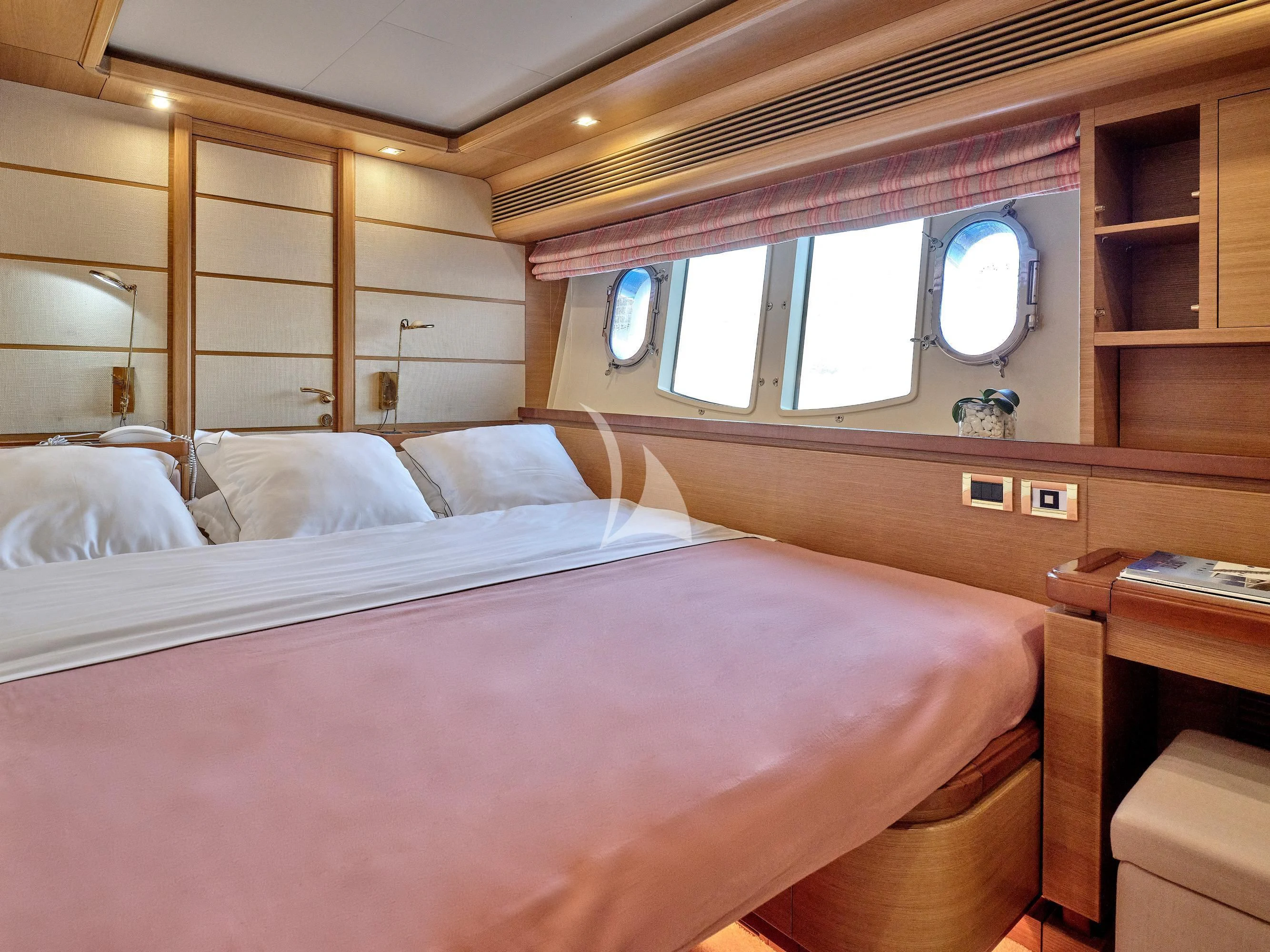 a room with a bed and a mirror aboard PAREAKKI Yacht for Sale