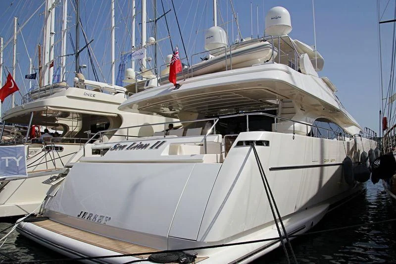 a white boat with a red stripe aboard PAREAKKI Yacht for Sale