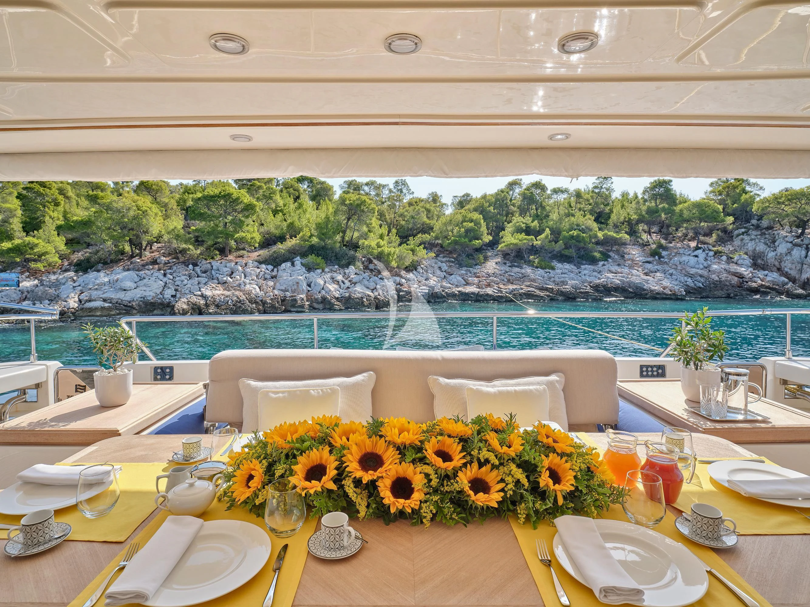 a table set with glasses and plates aboard PAREAKKI Yacht for Sale