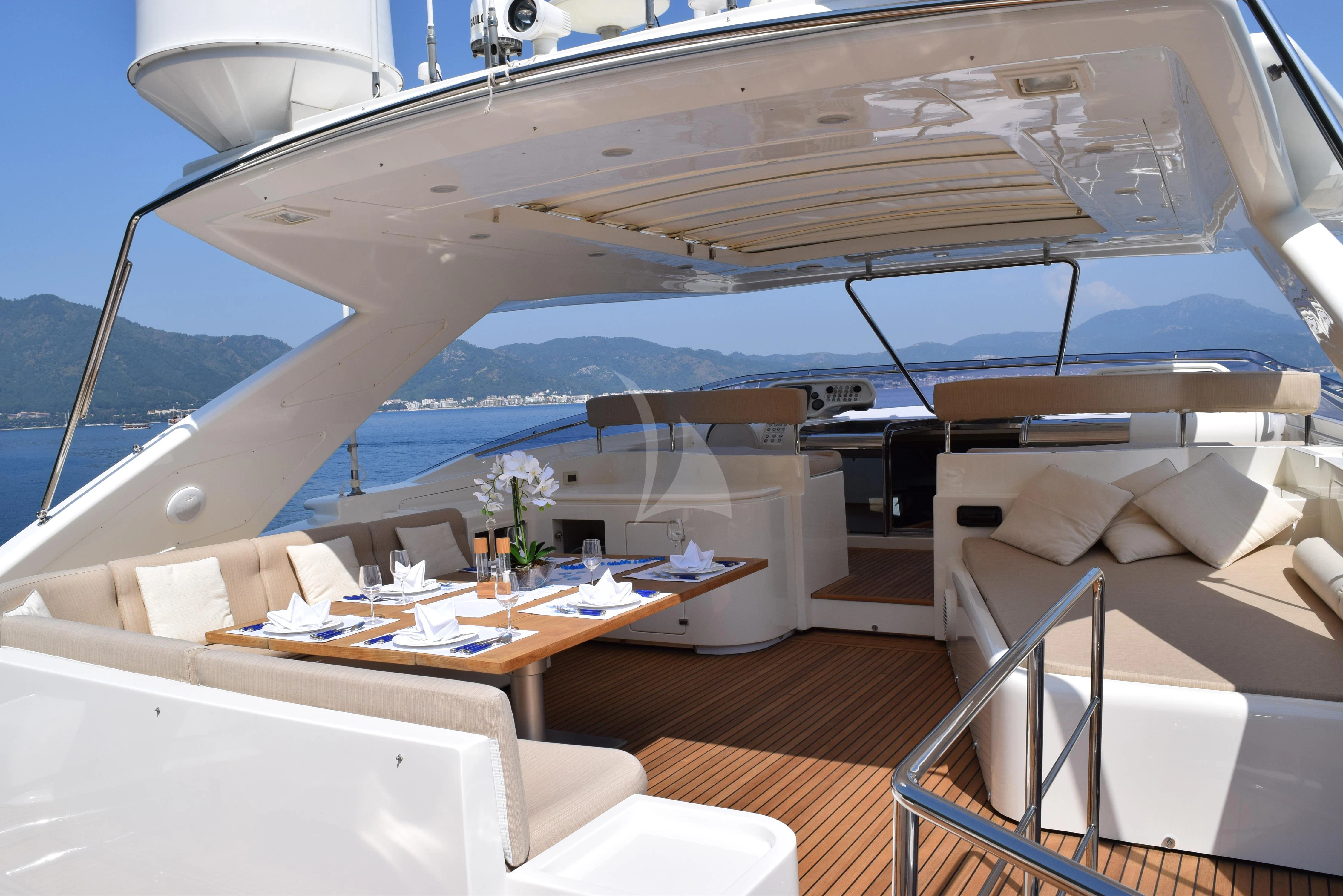 a room with a bed and a table and a couch aboard PAREAKKI Yacht for Sale