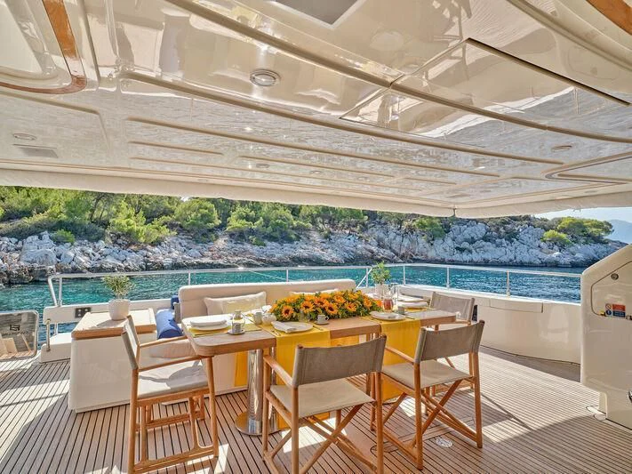 a table set for a meal on a deck aboard PAREAKKI Yacht for Sale