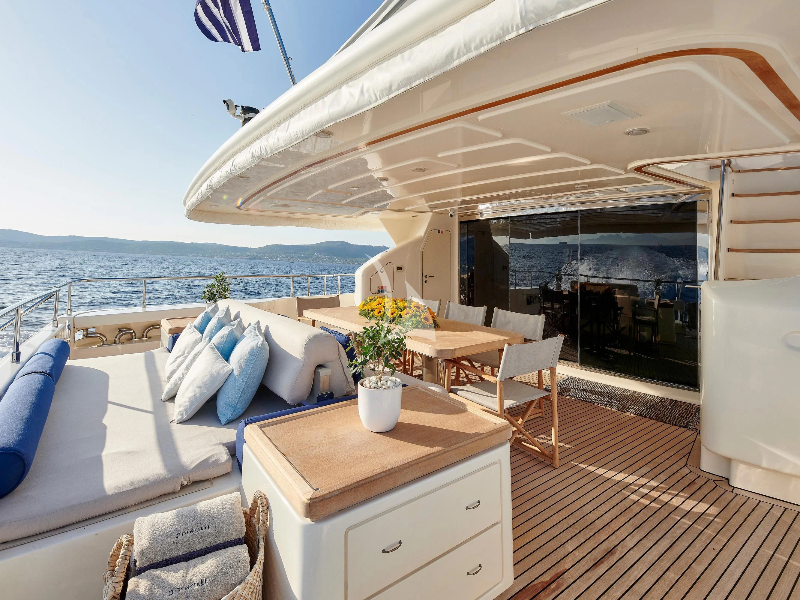 a room with a bed and a table and chairs aboard PAREAKKI Yacht for Sale