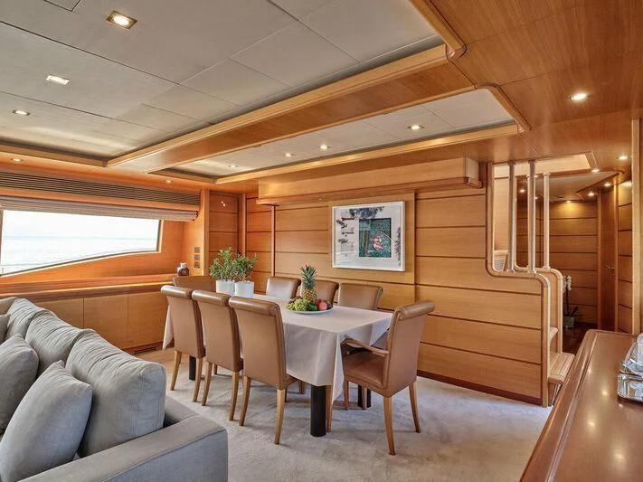 a room with a table and chairs aboard PAREAKKI Yacht for Sale